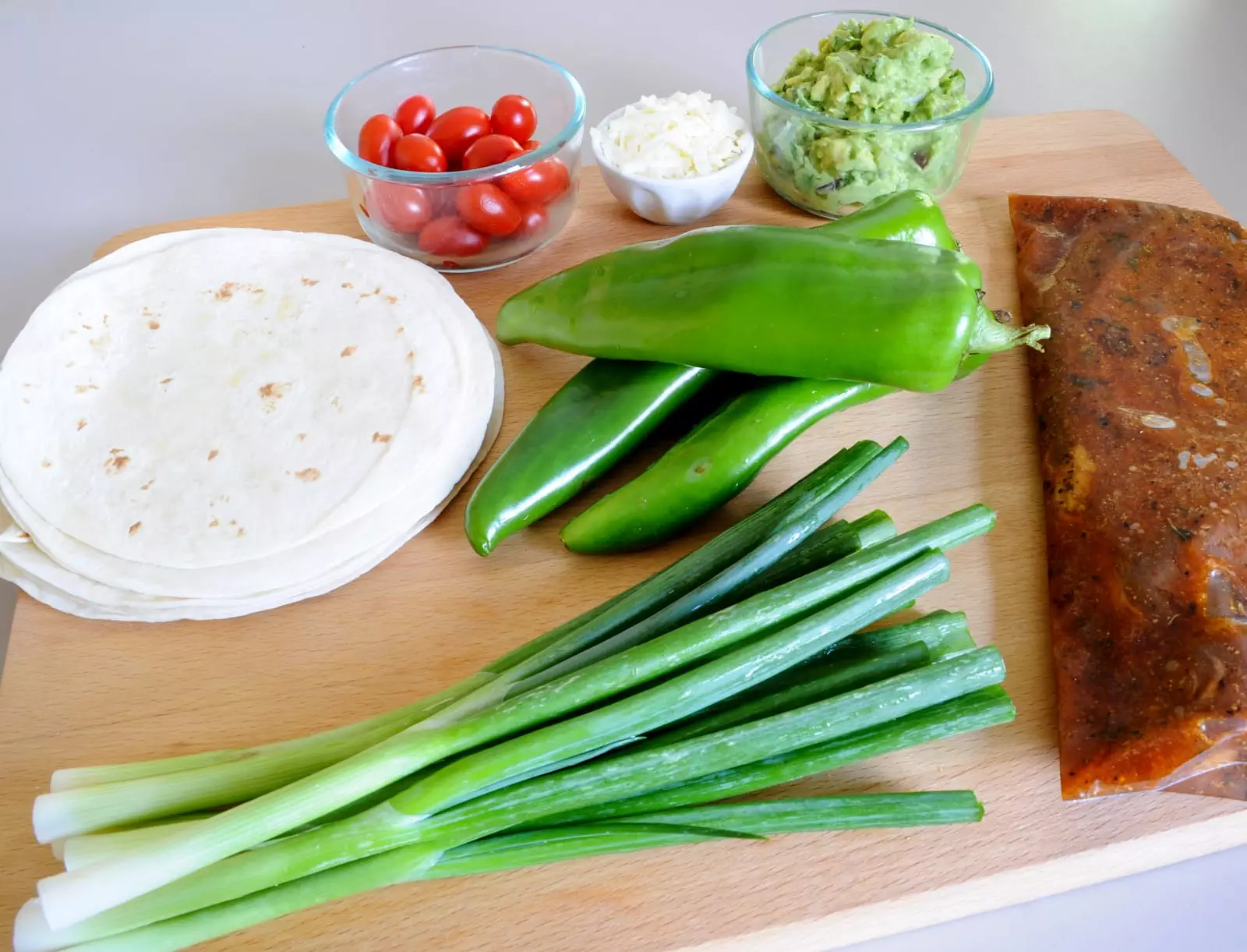 Steak, Anaheim Chile, and Scallion Tacos with Guacamole and Cotija Cheese