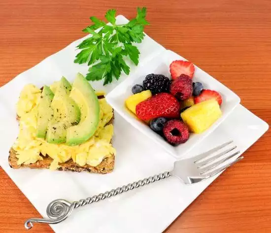 Fluffy Scrambled Eggs and Avocado Slices on Toast