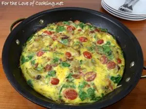 Baked Spanish Tortilla with Potato, Bacon, Onion, Mushroom, Tomato, Spinach, and Sharp Cheddar